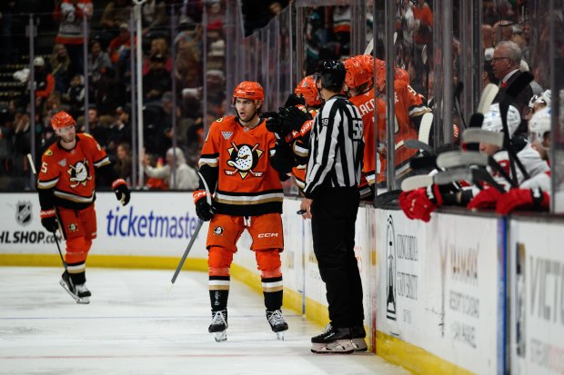 Ducks left wing Cutter Gauthier, center, greets teammates after scoring...
