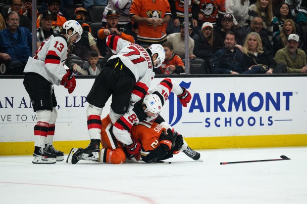 Ducks center Jansen Harkins, bottom, defends himself from New Jersey...