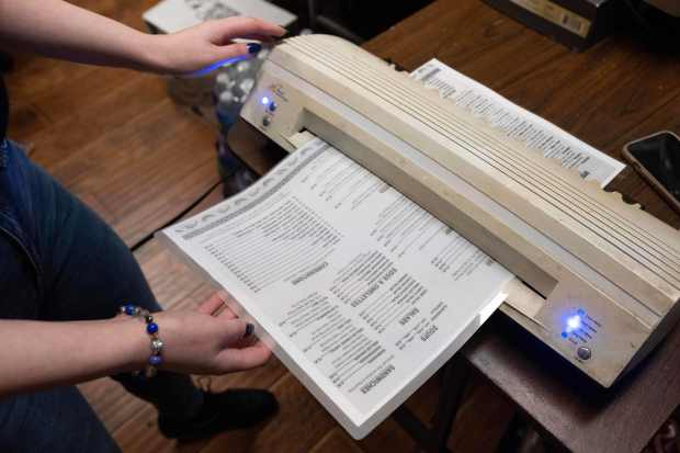 Sara Boblak quickly laminates new menus after fans of the...