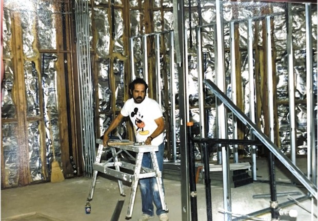 Nick Bagakis is shown doing drywall work at the still-new...