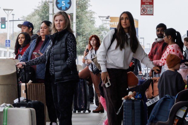 Travelers wait for their rides outside San Jose Mineta International Airport on Monday, Nov. 25, 2024, in San Jose, Calif. (Dai Sugano/Bay Area News Group)