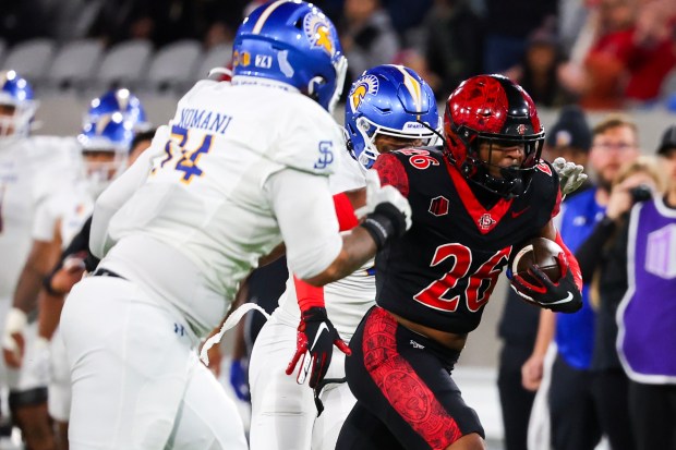 Dwayne McDougle #26 of San Diego State runs the ball after an interception against Daniel Moleni #54 of San Jose State during their game at Snapdragon Stadium on Saturday, Nov. 22, 2025 in San Diego, California. (Meg McLaughlin / The San Diego Union-Tribune)