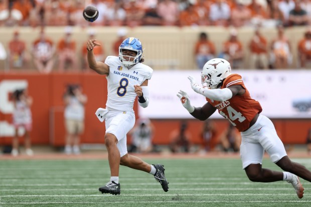 AUSTIN, TEXAS - SEPTEMBER 06: Tama Amisone #8 of the San Jose State Spartans throws a pass while defended by Brad Spence #14 of the Texas Longhorns in the second half at Darrell K Royal-Texas Memorial Stadium on September 06, 2025 in Austin, Texas. (Photo by Tim Warner/Getty Images)