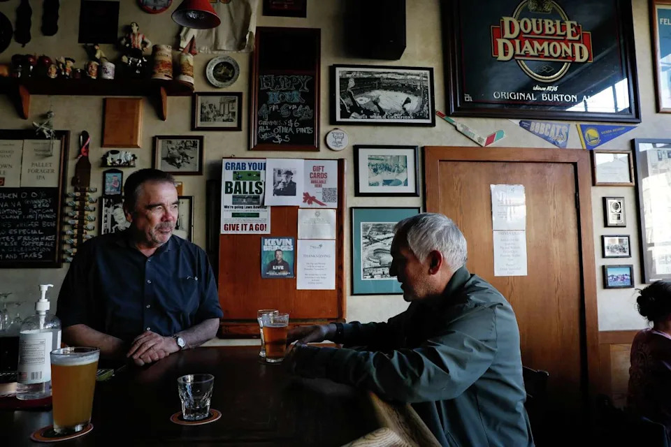 Steve Anderson, left to right, owner, and Paul Jasper, of San Francisco, talk at the bar at The Pig and Whistle on Friday, November 14, 2025 in San Francsico. (Lea Suzuki/S.F. Chronicle)