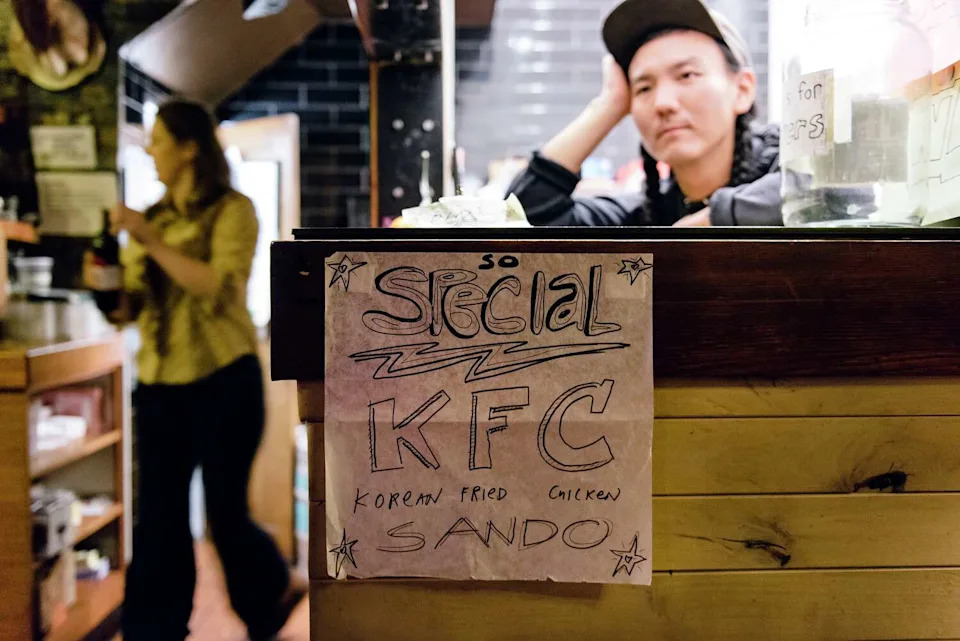 Chef Mike Yoon looks out of the delivery window of his pop-up diner Lovely's inside the Lodge bar in Oakland, in 2018. (Michael Short/Special to The Chronicle)