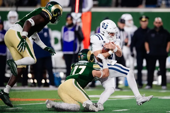 Utah State's Bryson Barnes keeps the ball during a game against CSU on Friday, Nov. 29, 2024 in Fort Collns, Colo.
