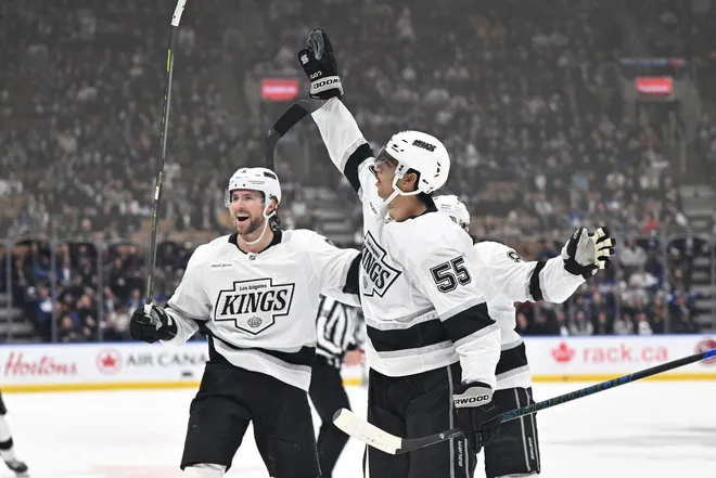 Nov 13, 2025; Toronto, Ontario, CAN; Los Angeles Kings forward Quintin Byfield (55) celebrates with forward Adrian Kempe (9) and defenseman Drew Doughty (8) after scoring the winning goal in overtime against the Toronto Maple Leafs at Scotiabank Arena.