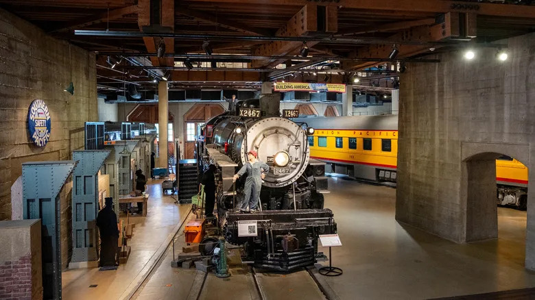 A mannequin of a railroad worker stands on a locomotive in the California State Railroad Museum