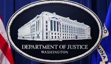 A U.S. Justice Department logo or seal showing Justice Department headquarters, known as "Main Justice," is seen behind the podium in the Department's headquarters briefing room before a news conference with the Attorney General in Washington, January 24, 2023. (Reuters/Kevin Lamarque)
