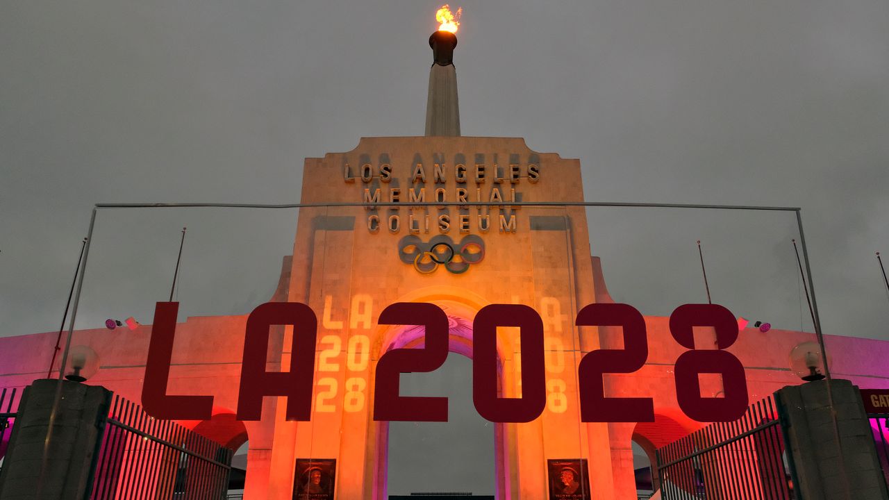 An LA 2028 sign is seen in front of the Olympic cauldron at the Los Angeles Memorial Coliseum on Sept. 13, 2017. (AP Photo/Richard Vogel, File)