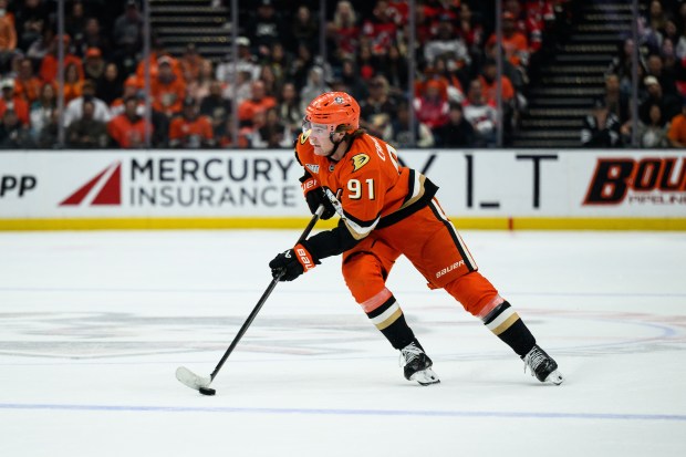 Ducks center Leo Carlsson looks to pass the puck during...