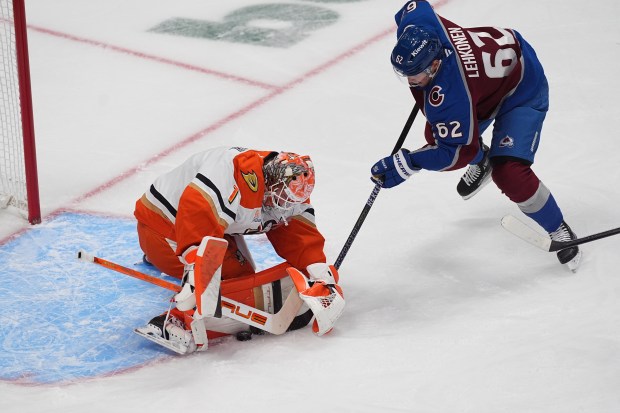 Ducks goaltender Lukas Dostal, left, stops a shot by Colorado...