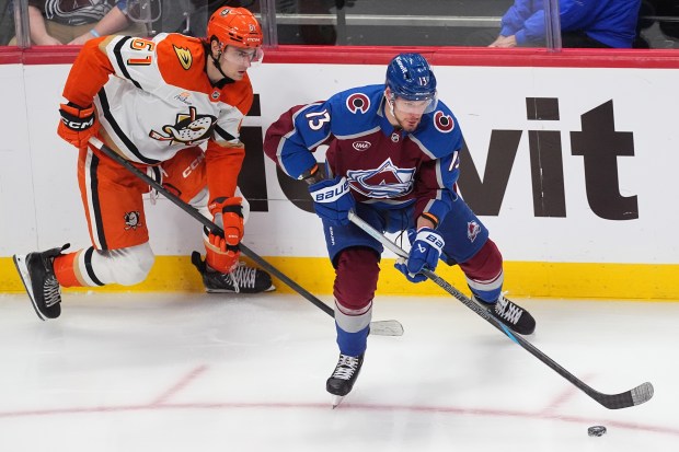 Colorado Avalanche right wing Valeri Nichushkin, right, collects the puck...