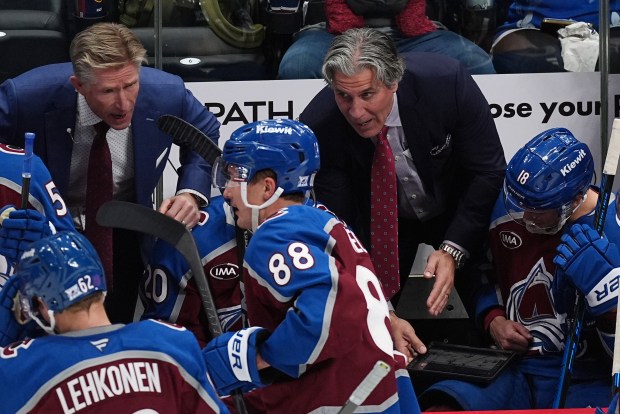 Colorado Avalanche head coach Jared Bednar, back right, and assistant...