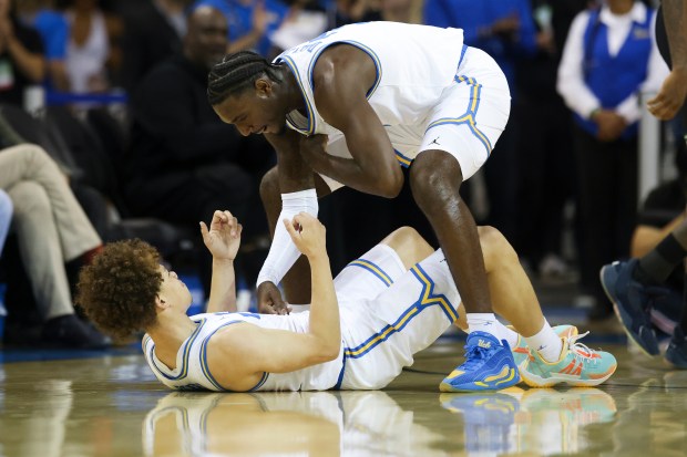 UCLA forward Eric Dailey Jr., top, and guard Trent Perry...