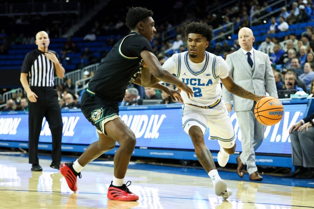UCLA guard Donovan Dent (2) drives against Sacramento State guard...