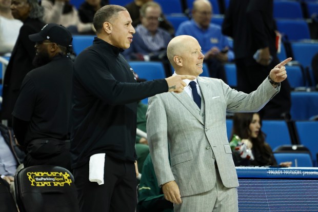 Sacramento State head coach Mike Bibby, left, and UCLA head...