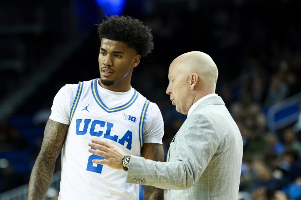 UCLA guard Donovan Dent (2) interacts with UCLA head coach...