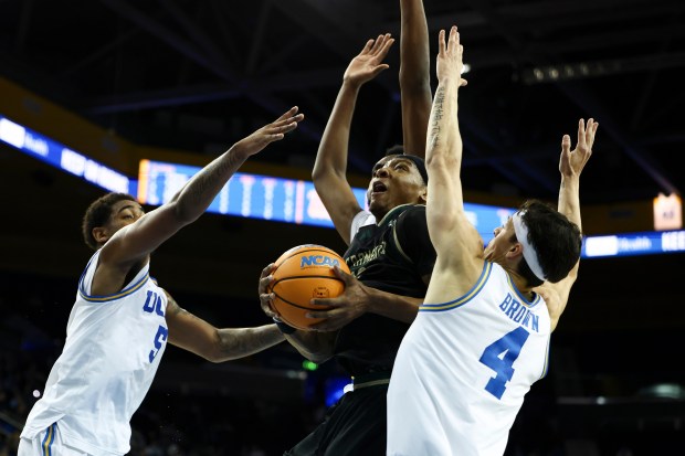 Sacramento State guard Prophet Johnson, center, drives to the basket...