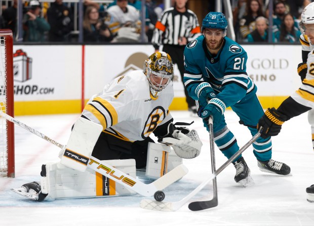 San Jose Sharks’ Alexander Wennberg (21) tries to get the...