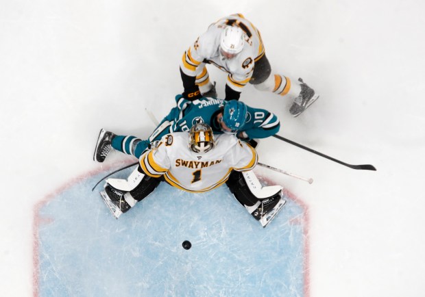 San Jose Sharks’ Ty Dellandrea (10) collides with Boston Bruins...
