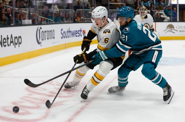 San Jose Sharks’ Alexander Wennberg (21) fights for the puck...