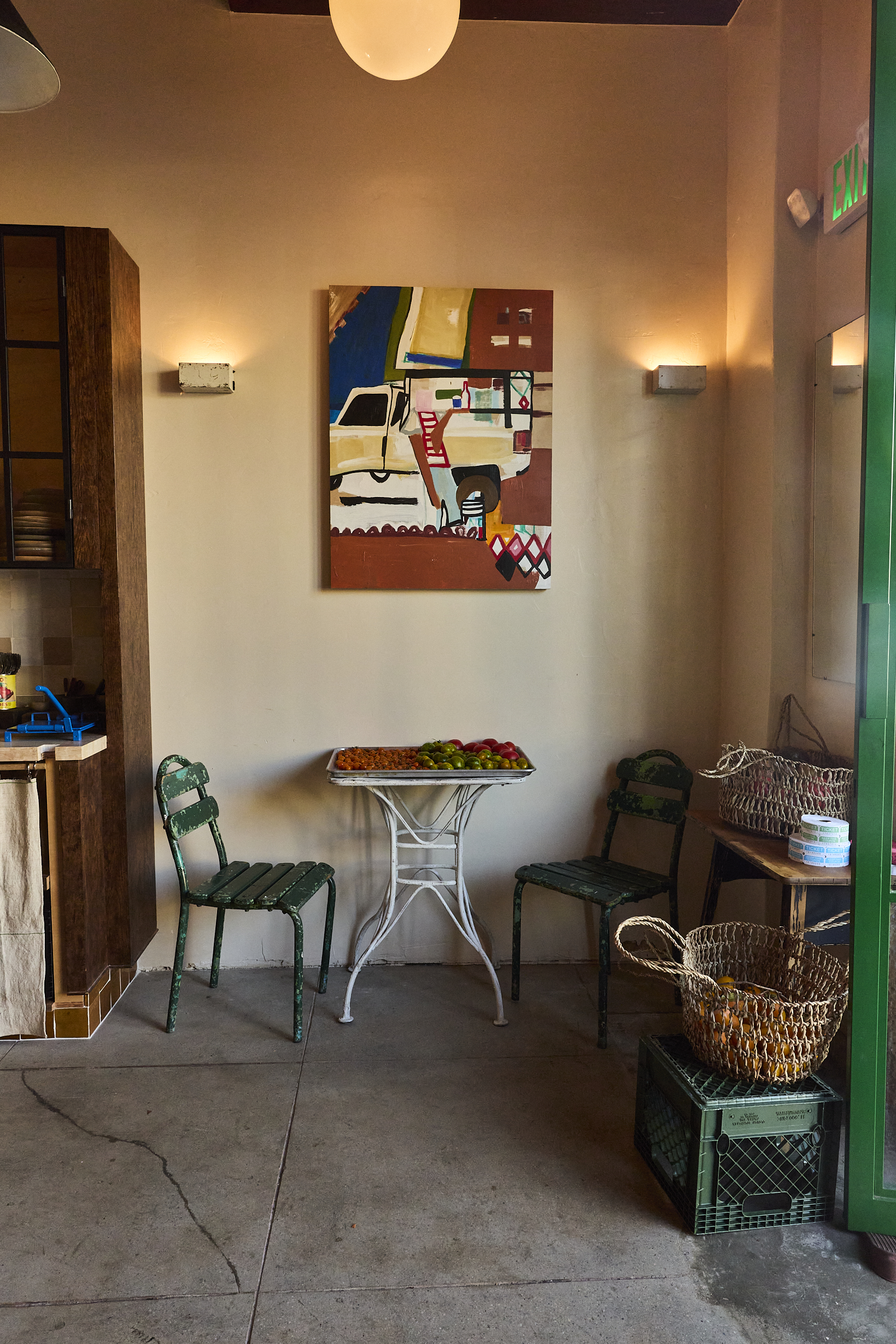 Seating at a table with art over it at Chainsaw