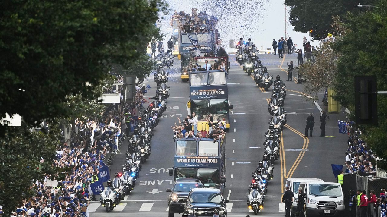 Los Angels Dodgers players and staff ride on a double-decker bus during a parade to celebrate the baseball team's World Series win on Monday, Nov. 3, 2025, in Los Angeles. (AP Photo/Jae C. Hong)