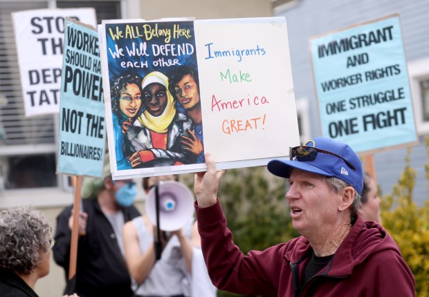 Barry Pike and other community members take part in an...
