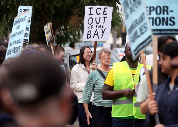 Community members take part in an U.S. Immigration and Customs...