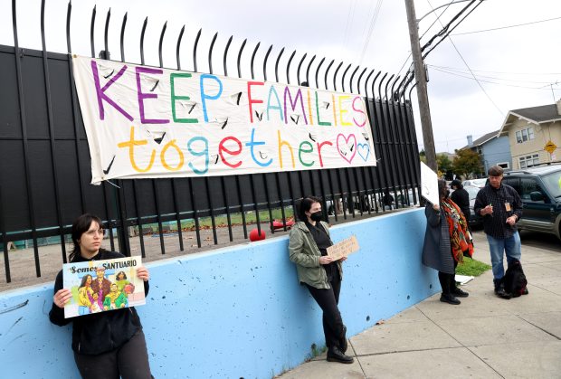 Community members take part in an U.S. Immigration and Customs...