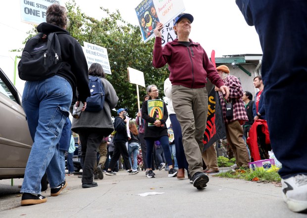 Barry Pike, right, and other community members take part in...