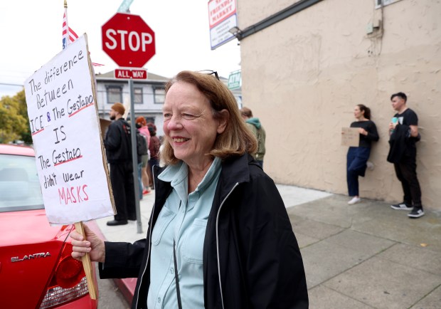 Sara Hanes and other community members take part in an...