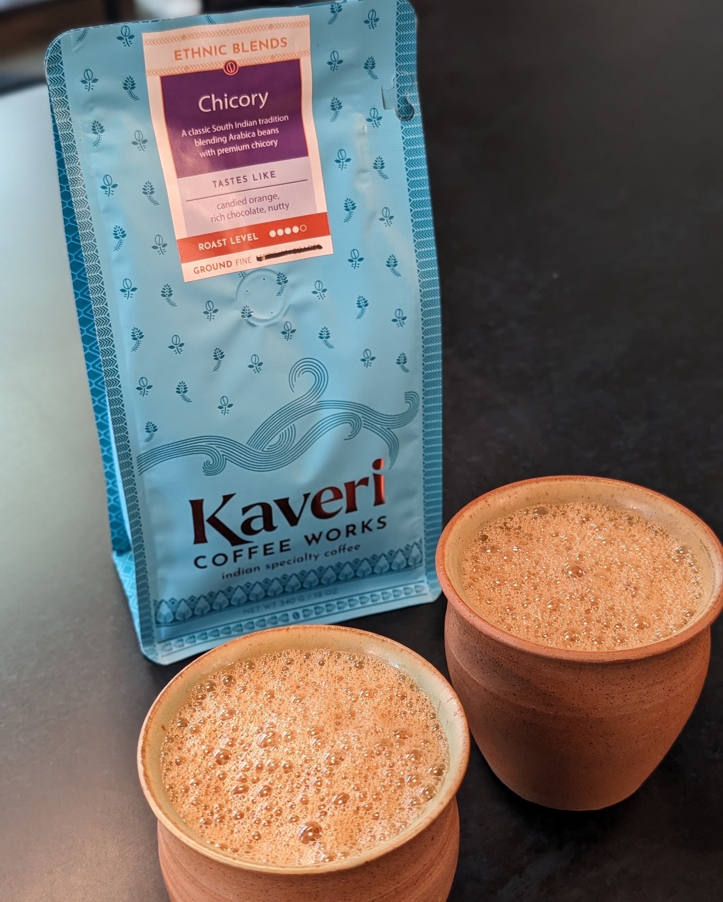 A bag of coffee and two cups.