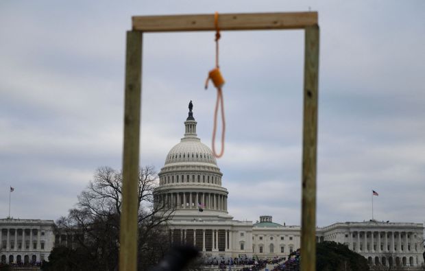 A noose is seen on makeshift gallows as supporters of US President Donald Trump gather on the West side of the US Capitol in Washington DC on January 6, 2021. - Donald Trump's supporters stormed a session of Congress held today, January 6, to certify Joe Biden's election win, triggering unprecedented chaos and violence at the heart of American democracy and accusations the president was attempting a coup. (Photo by Andrew CABALLERO-REYNOLDS / AFP) (Photo by ANDREW CABALLERO-REYNOLDS/AFP via Getty Images)