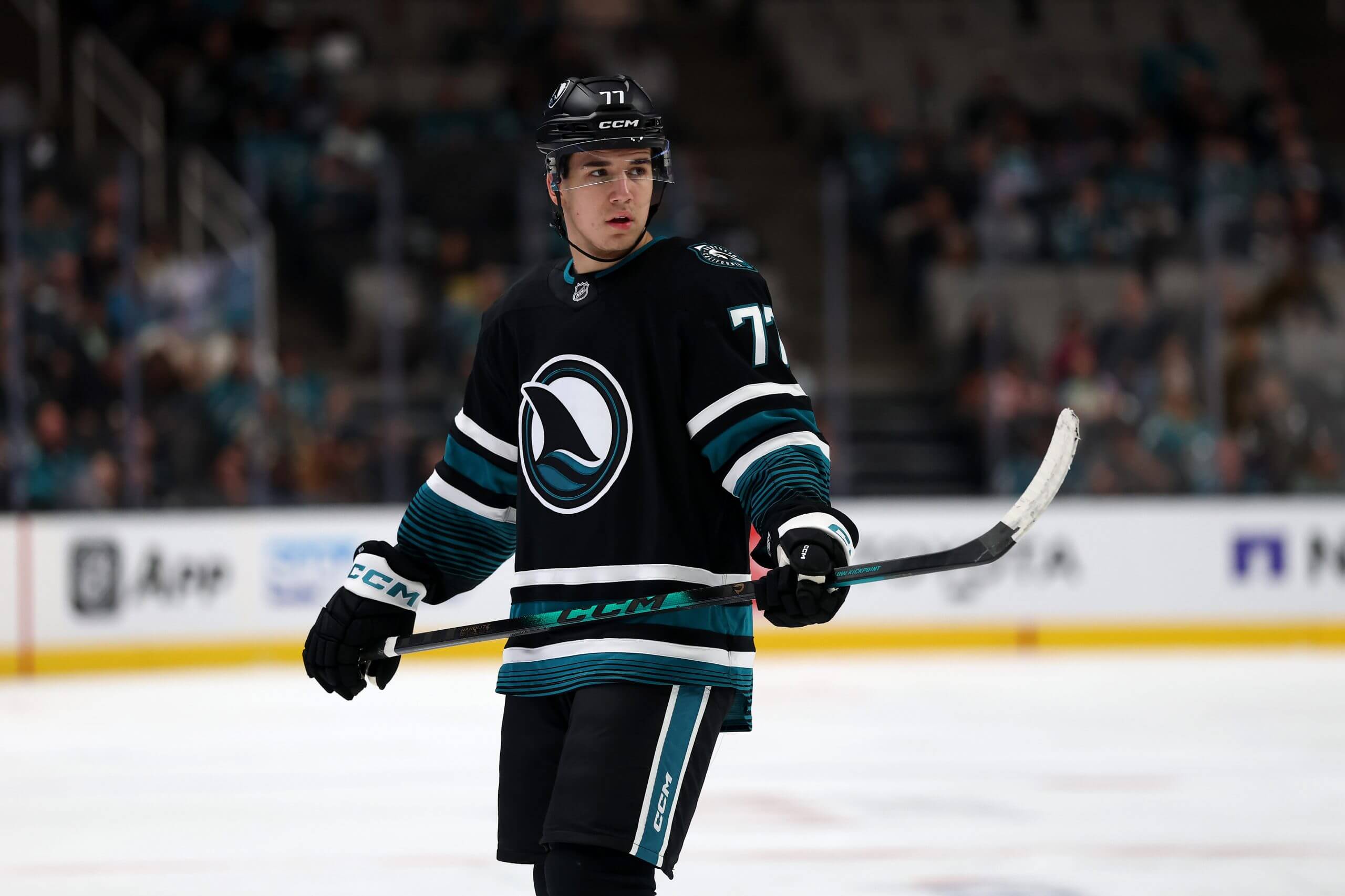 Michael Misa stands on the ice during a pause in play.