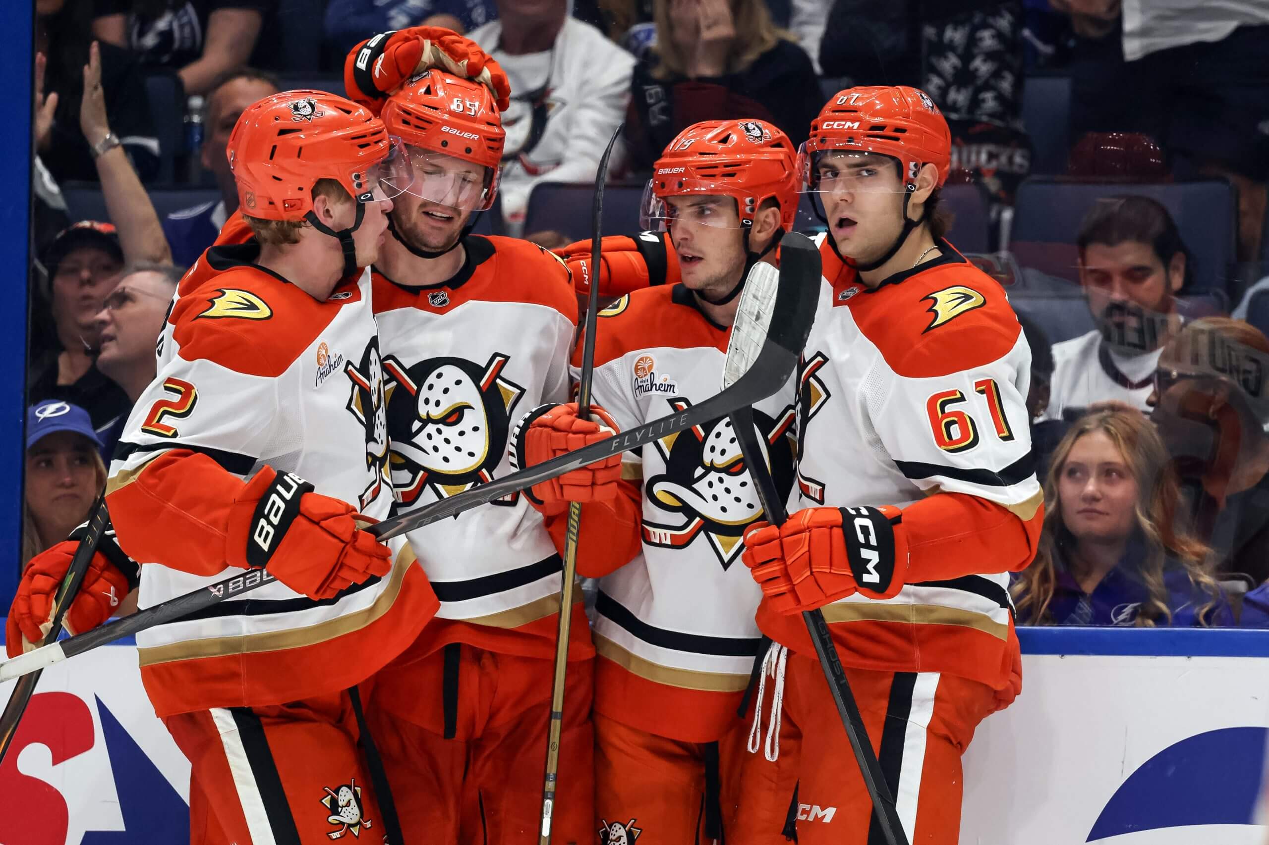 Jacob Trouba gets a hug from Cutter Gauthier, Troy Terry and Jackson LaCombe.