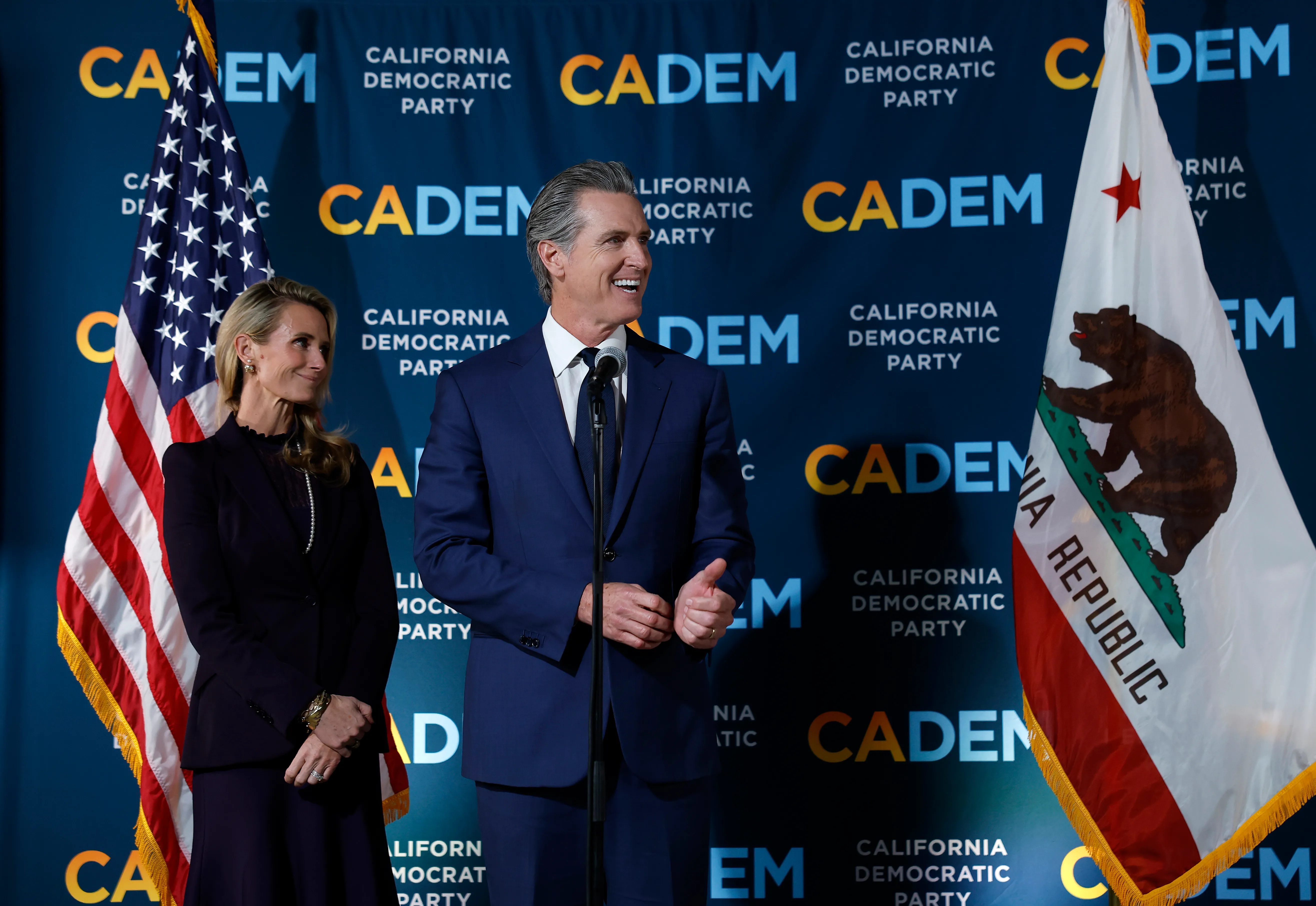 SACRAMENTO, CALIFORNIA – NOVEMBER 04: California Gov. Gavin Newsom (R) speaks as his wife Jennifer Siebel Newsom (L) looks on during an election night gathering at the California Democrats headquarters on November 04, 2025 in Sacramento, California. California voters approved Proposition 50, a measure that will replace the state’s current congressional district map with new, legislature-drawn lines from 2026 through 2030.  (Photo by Justin Sullivan/Getty Images)