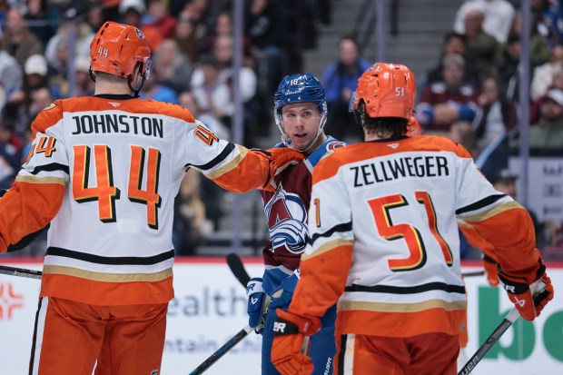 The Colorado Avalanche’s Jack Drury, center, confronts the Ducks’ Ross...