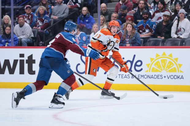 The Ducks’ Leo Carlsson, right, skates with the puck during...