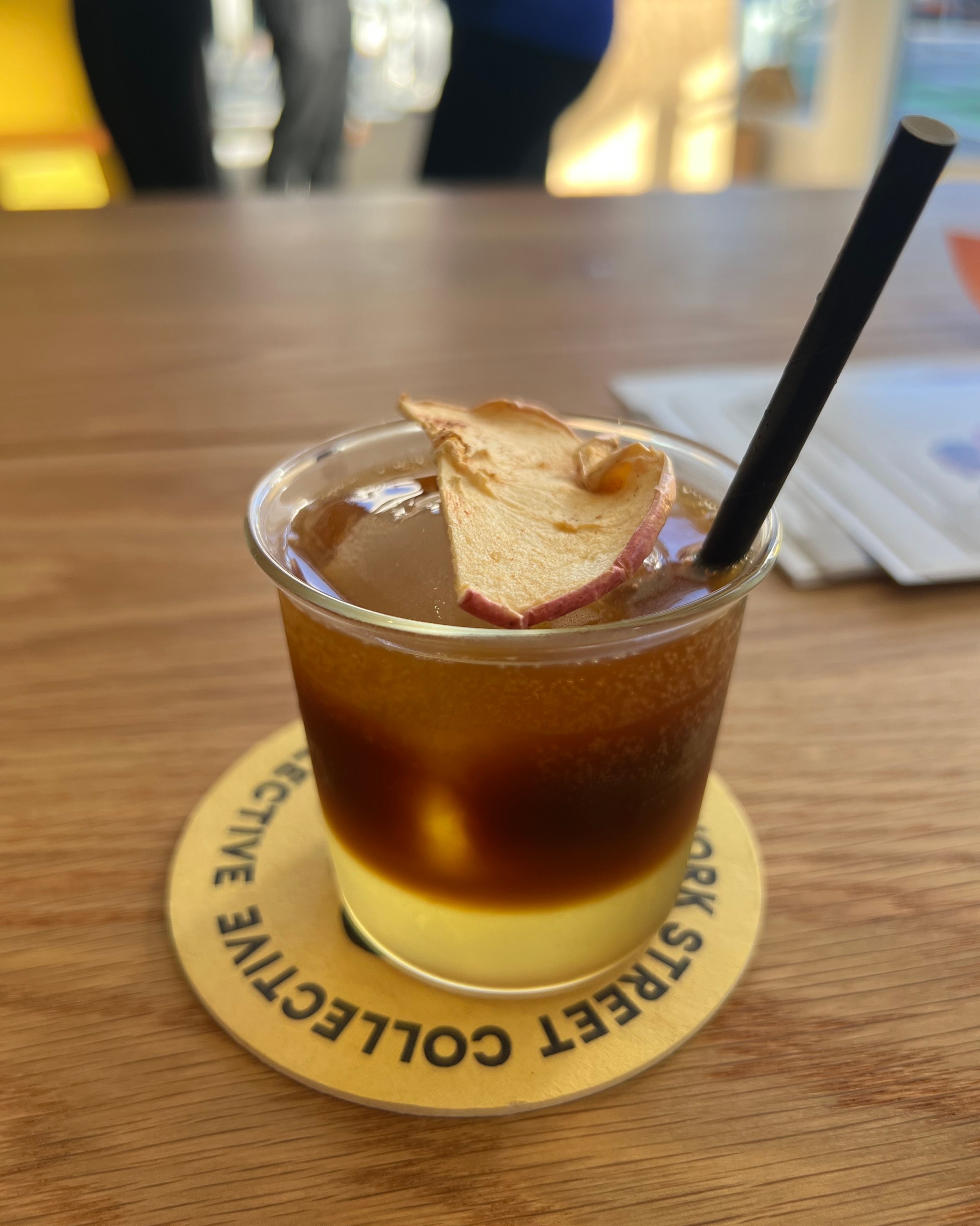 A glass with fruit on top.