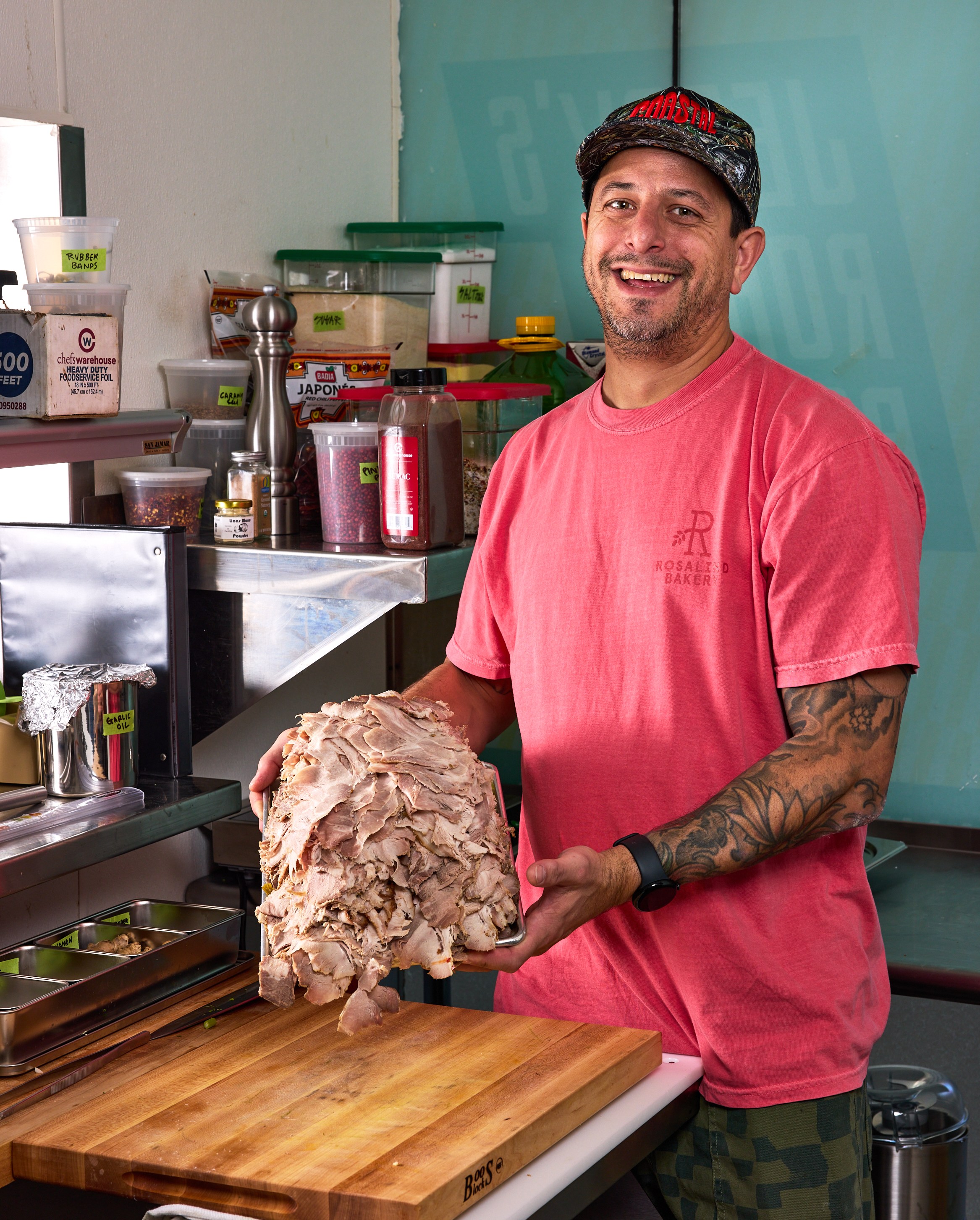 Rosalind Bakery owner Matthew Kosoy poses with a tray of sliced roast pork at his new San Francisco shop, Jerry’s Roast Pork.