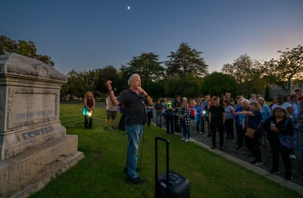 Author and historian, Chris Epting, center, speaks near the gravesite...