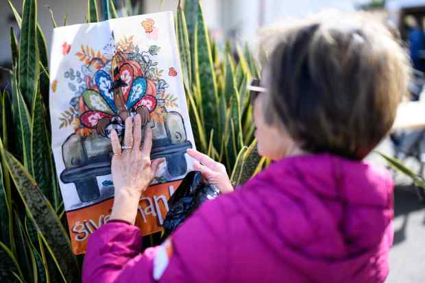 A volunteer puts up a Thanksgiving poster at the HUB...