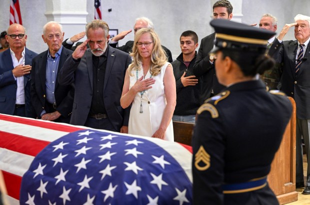 Jared Chandler, center, and Courtney Gebhart, parents of U.S. Army...