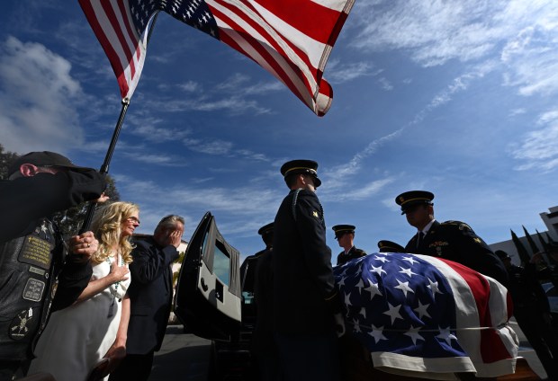 Courtney Gebhart, left, joins Jake Chandler, as their son, U.S....