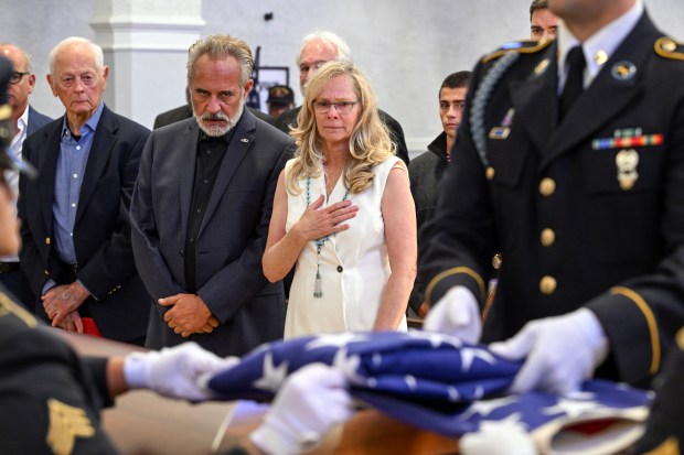 Jared Chandler, center, and Courtney Gebhart, parents of U.S. Army...