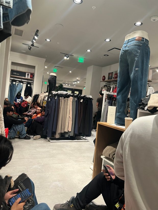 Shoppers take shelter inside the Abercrombie & Fitch store at...