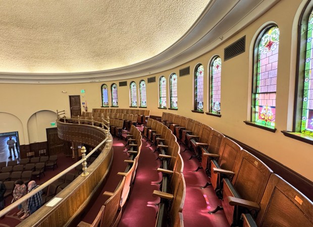 Wooden theater seats fill the balcony of the First Unitarian...
