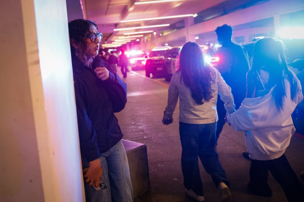 People leave while police investigate a shooting incident at Valley...